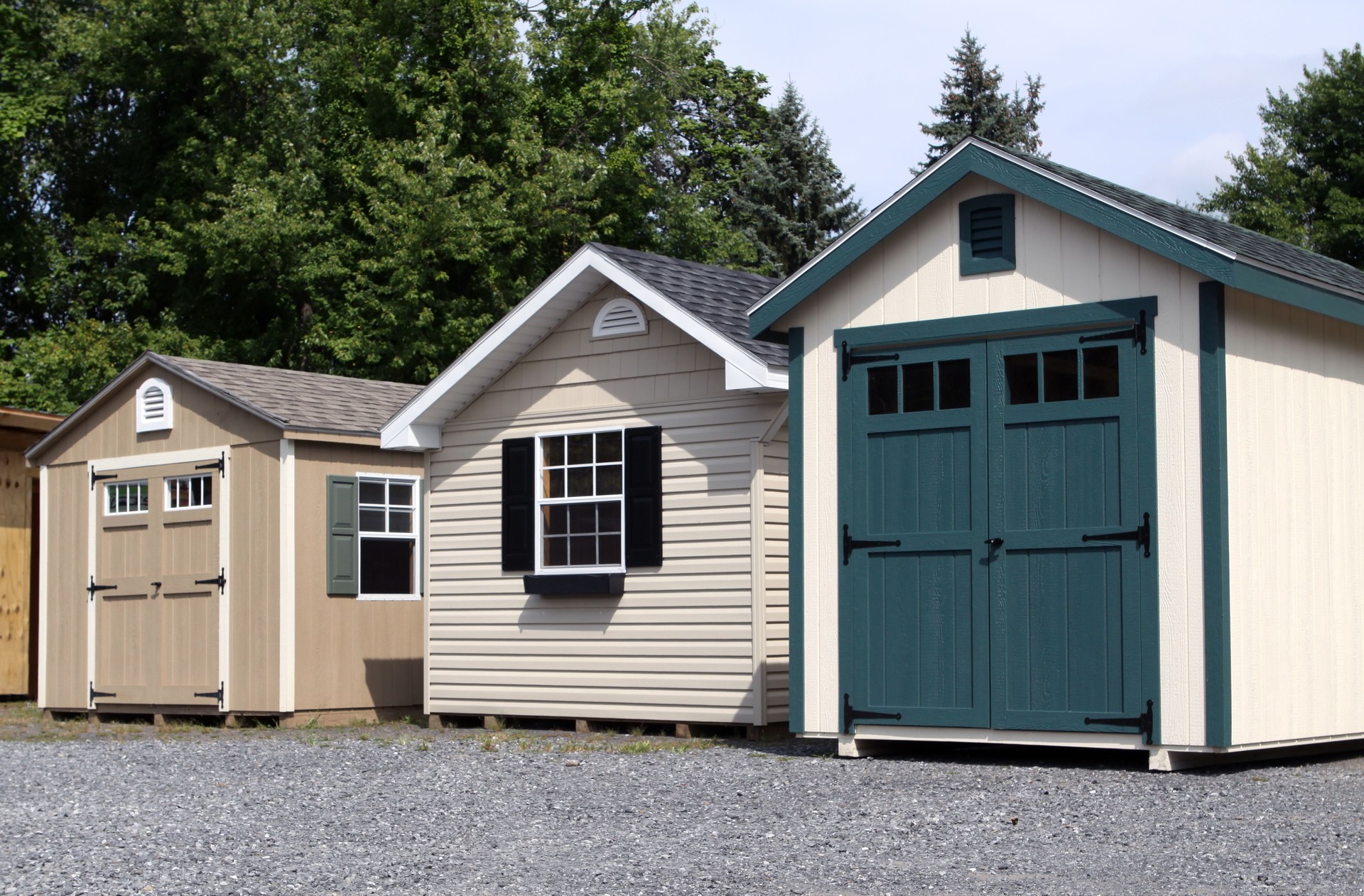 Landscape shot of a row of garden sheds on gravel